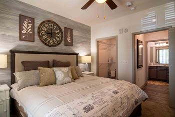 a bedroom with a large bed and a clock on the wall  at Century New Holland, Gainesville